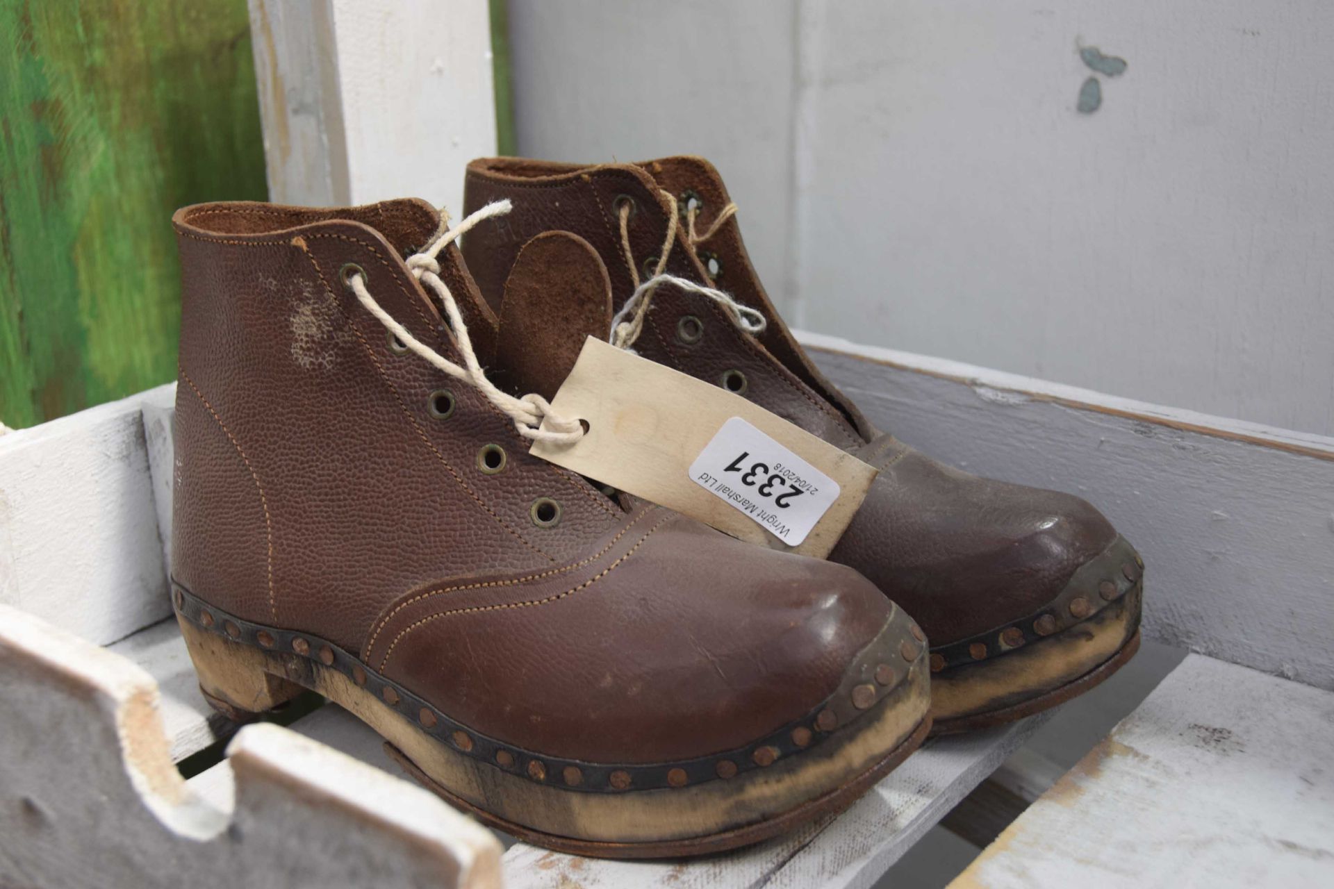 Pair brown leather clogs.