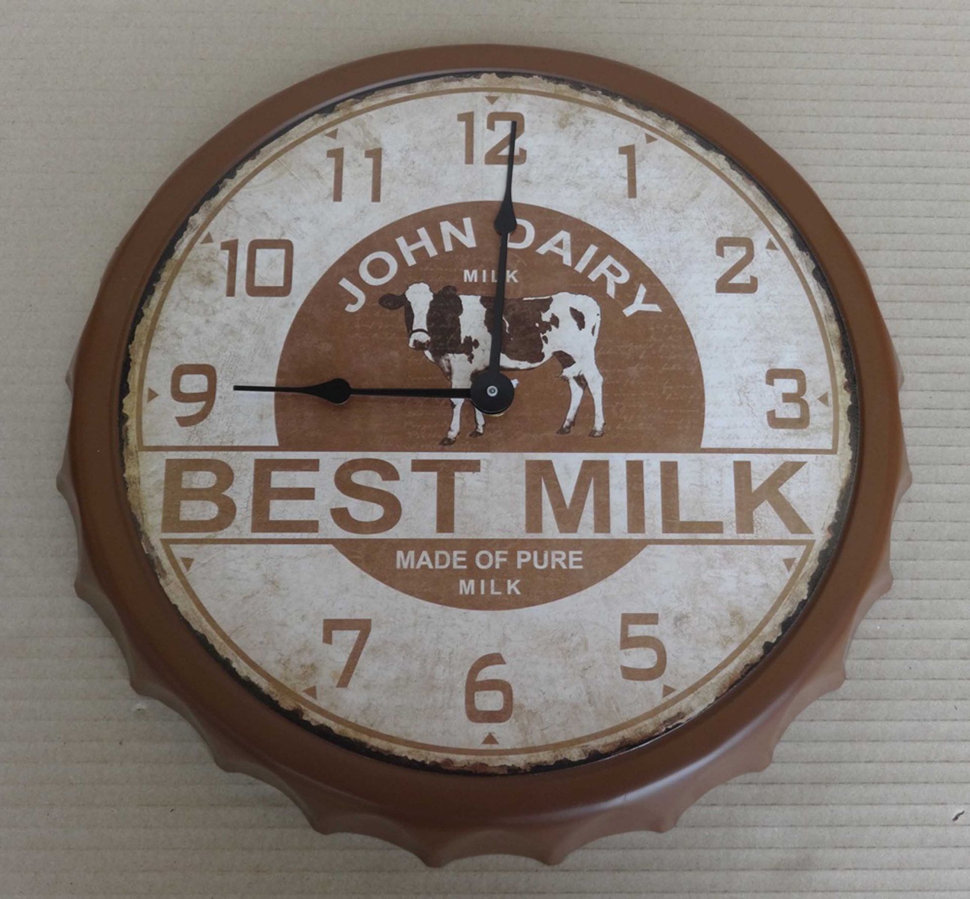 A group of five novelty milk bottle top wall clocks, 33x33x5cm.