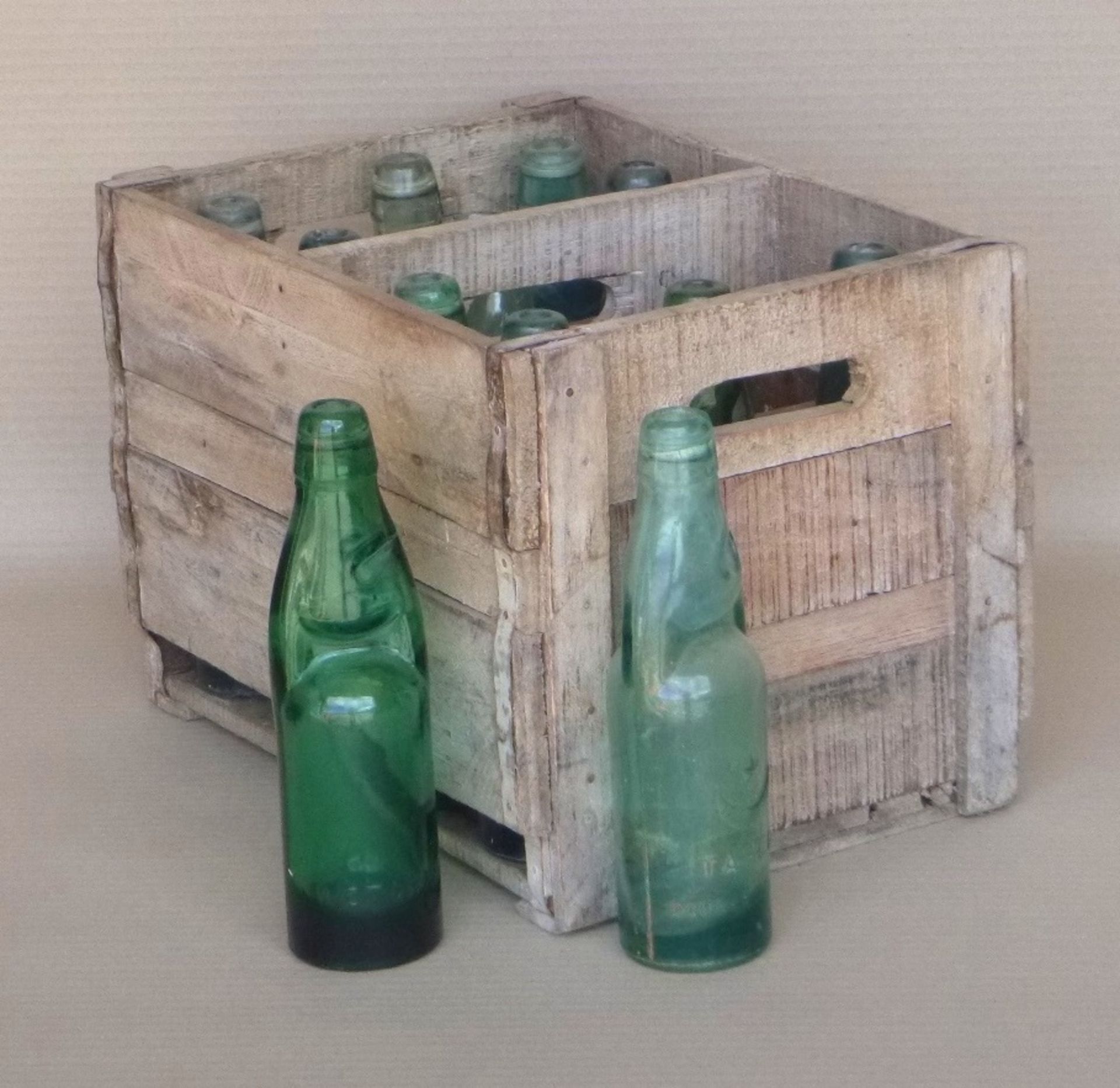 Small bottle crates and twelve cod bottles.