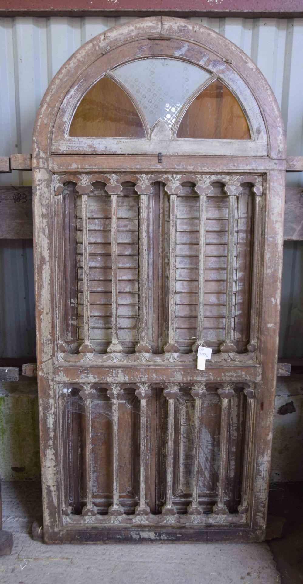 Wooden panelled shutter windows with iron grills and glazed ventilators.