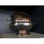 A silver-plated soup tureen with ladle and sauceboat.