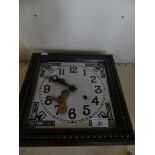 A 20th Century oak cased square faced wall clock.