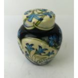 A Moorcroft pottery ginger jar and cover Decorated with blue floral sprays on an ivory and blue