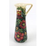 A Moorcroft pottery ewer of tapering cylindrical form Decorated with floral sprays,