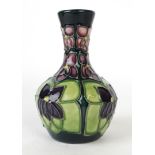 A Moorcroft pottery vase of squat form with cylindrical neck Decorated in the Violet pattern,