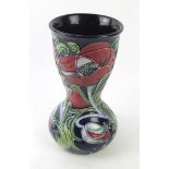 A Moorcroft pottery vase of bulbous form with cylindrical neck Possibly decorated in the Wilverley