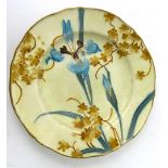 A Minton Secessionist plate of circular form with scalloped edge Decorated with stylised flowers in