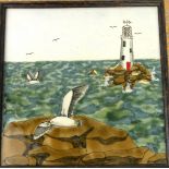 A Cobridge Stoneware plaque Decorated with sea gulls and lighthouse,