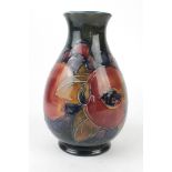 A William Moorcroft vase of baluster form Decorated in the Pomegranate pattern on a blue ground,