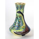 A Moorcroft enamel vase of baluster form Decorated with a Peacock on a mustard ground,