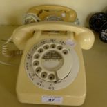Two retro cream plastic telephones.
