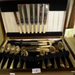 A early 20th Century oak canteen of silver-plated cutlery.