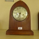 An early 20th Century arched topped mahogany cased mantel clock.