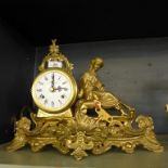 A 20th Century brass cased mantel clock with figural mount, fitted with a German movement.