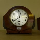 A small domed top mantel clock with Art Deco type decoration.