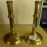 A pair of Georgian brass ejector candlesticks each having double knopped columns,