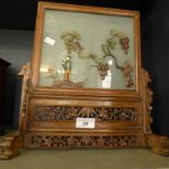 A 20th Century Oriental hardwood and glass screen with pierced floral decoration