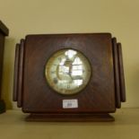 An oak cased mantel clock in the Art Deco style.