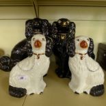 A collection of six Staffordshire model spaniels of varying designs.