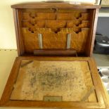 An early 20th Century oak desk tidy cabinet, with fall front and fitted interior,