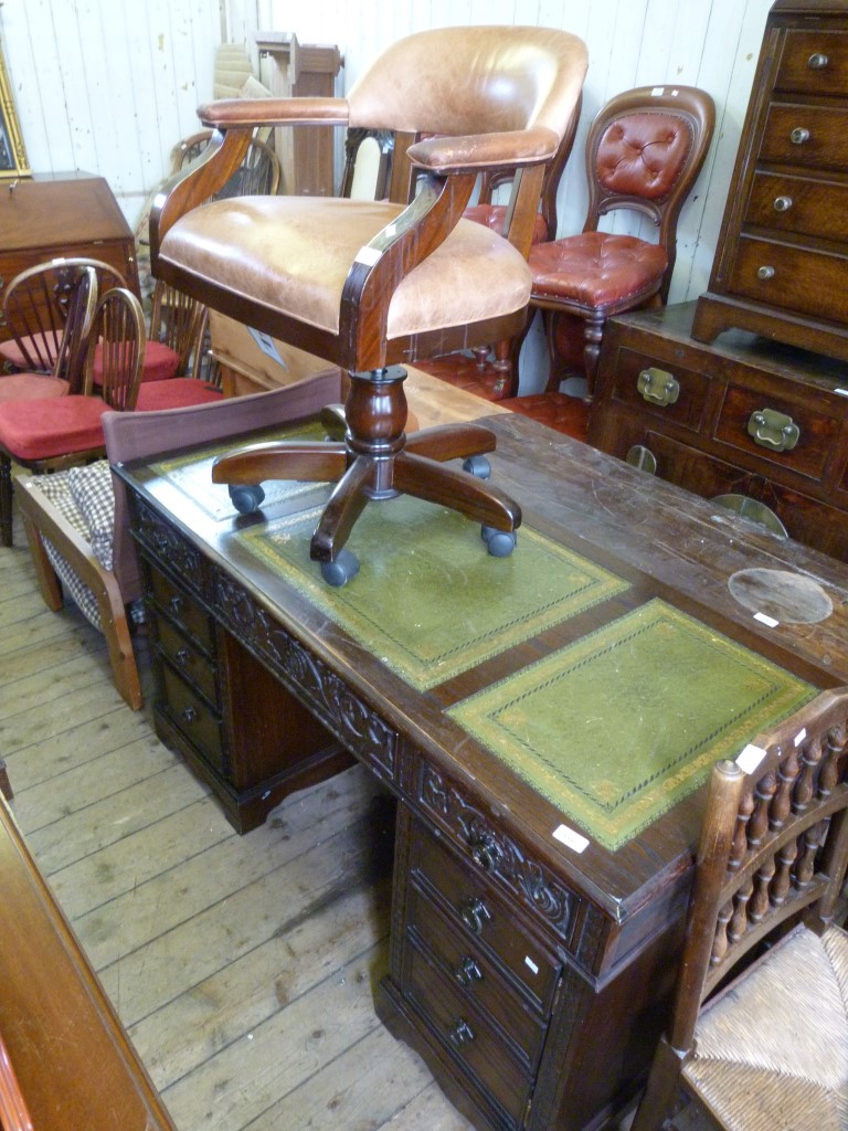 A reproduction dark oak flat top kneehole desk,