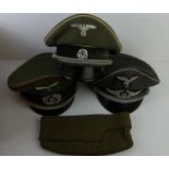 Three assorted German Officers Caps Each cap with eagle and swastika badge,