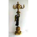 A large late 19th/early 20th Century gilt metal and bronze candelabra The four branch top over a