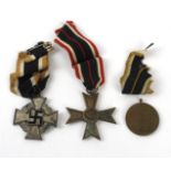 A collection of Nazi Germany medals To include Faithful Service Declaration medal, War Merit Cross,