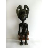 A West African carved wooden maternity figure,