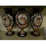 A set of three late 19th Century Continental opaque glass vases decorated with portrait panels and