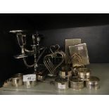 A mixed lot of various silver-plated wares to include toast racks, napkin rings, candelabra, etc.