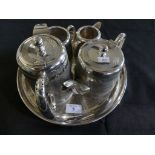 A silver-plated four piece tea service with accompanying tray, decorated with engined turned detail