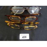 Four pairs of Gucci reading glasses to include full and half frames, in brown, tortoiseshell