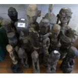 A collection of Indonesian carved wooden figures of varying designs