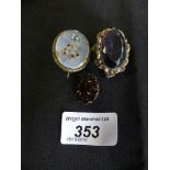 A selection of gem-set brooches to include a garnet cluster brooch and two others (3)