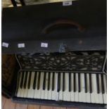 A cased Varsity piano accordion