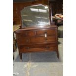 An Edwardian mahogany dressing table Having a shaped mirrored plate raised on two uprights of square
