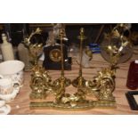 A collection of fireside brass items To include a foliate design brass fender with two scroll and