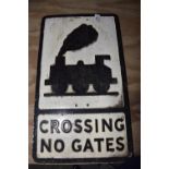 A cast iron road sign The road sign (30.5 x 53cm) picked out in raised lettering 'Crossing no Gates)