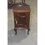 An Edwardian mahogany pot cupboard Having a twin swan neck pediment above a square moulded top and a