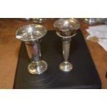 Two silver vases Each with a circular base, tapered body and flared rim, together with a base