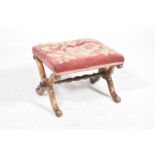 A 19th Century walnut X frame stool Having a rectangular embroidered seat supported on two X frame