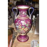 A large Staffordshire porcelaneous twin handled vase The 57cm high vase raised on pedestal shaft