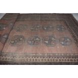 A Persian style rug The red ground rug with with blue and red boarders, with central rectangular