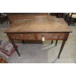 A 19th Century oak side table Having a rectangular top above two frieze drawers raised on tapering
