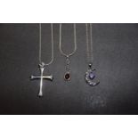 Three necklaces To include a cross pendant, a cubic zirconia crescent pendant and one other, total