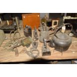 A collection of iron works To include four flat irons, stirrups, kettle, three jugs - two jugs