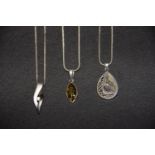 Three necklaces To include an amber pendant, an abalone pendant and one other, stamped 925, total