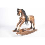 A modern painted hard wood rocking horse Applied with mane and tail, fitted with saddle leathers ,