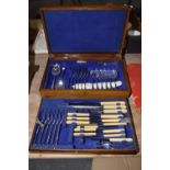 A wooden canteen of cutlery Comprising of six dining forks, six desert spoons, four teaspoons,